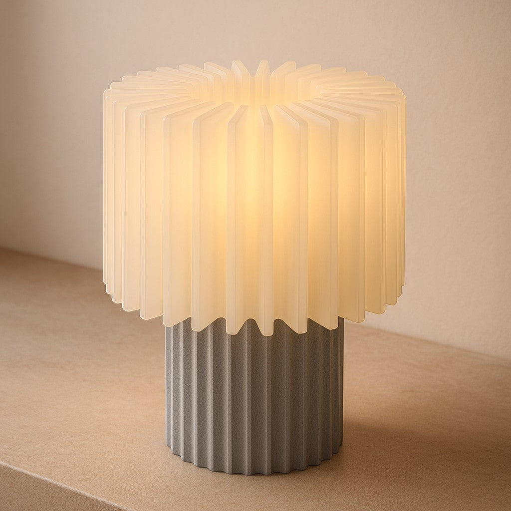 My Store Layyo Glowry table lamp with white pleated shade and grey fluted base, emitting warm light.